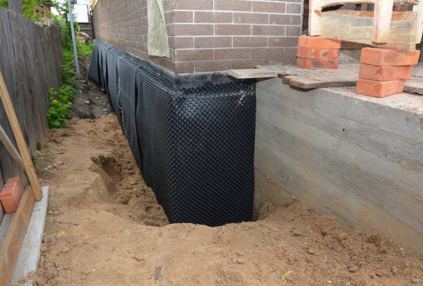 Happy homeowners after waterproofing job in Blaine